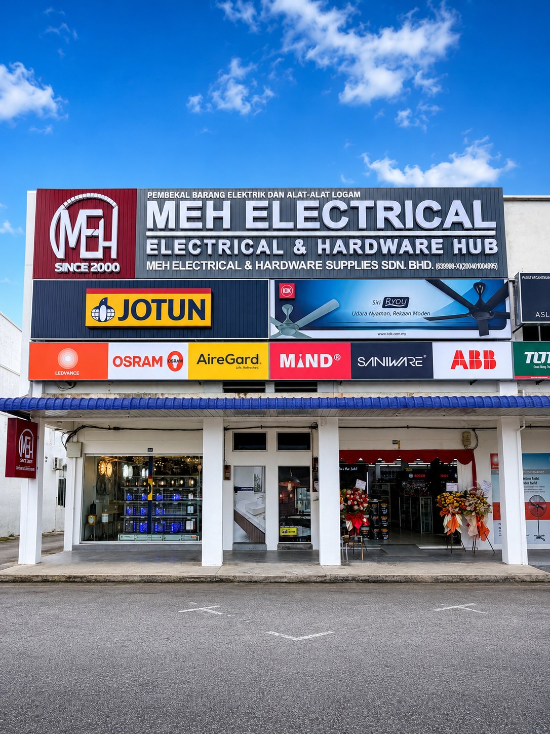 Three-unit shoplot with an MEH Electrical & Hardware Hub signboard, a Jotun sign and a row of electrical brand logos