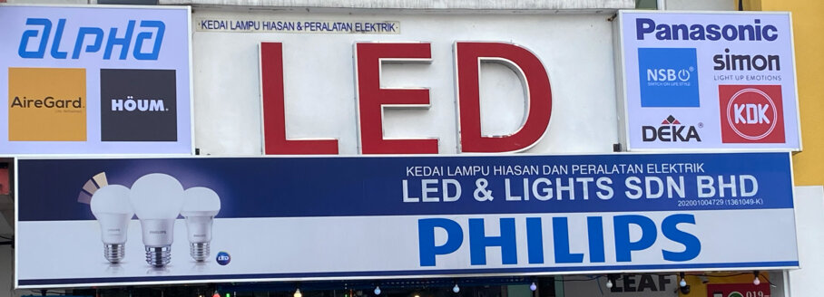 Shop signboard with a large red LED sign, a blue Led & Lights Sdn Bhd Philips panel and several brand logos