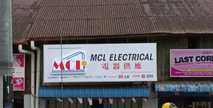 White shop signboard reading MCL Electrical with Chinese characters and a row of brand logos including Schneider, Hager, LS, Joven and EPS, under a rusty corrugated roof on an old shophouse