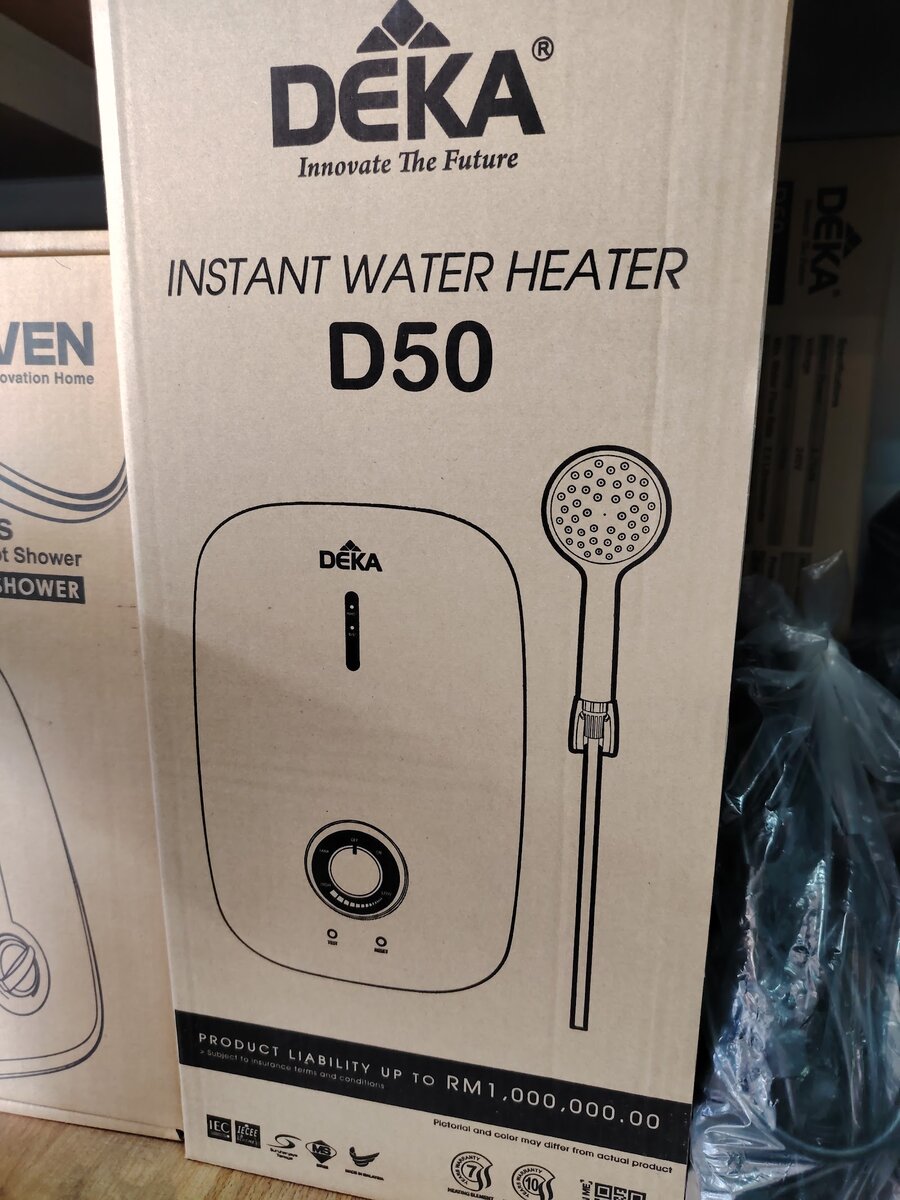 Cardboard box printed Deka Instant Water Heater D50 with a line drawing of the heater and hand shower