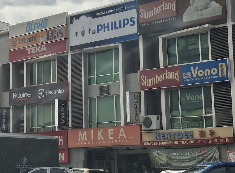 Row of three-storey shophouses with an orange Mikea Lighting Centre fascia and a Philips signboard above it