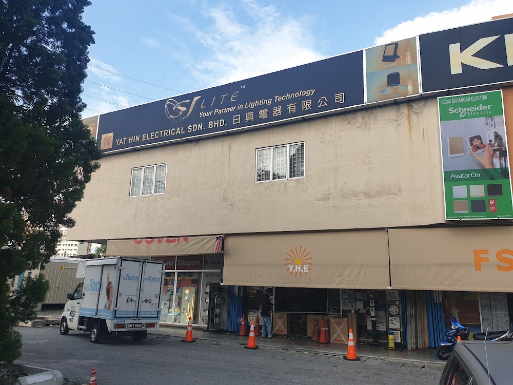 Corner shoplot with an SJ Lite fascia sign for Yat Hin Electrical Sdn Bhd and a Schneider Electric AvatarOn wall panel